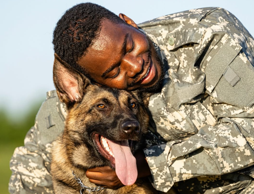 A veteran embracing his service dog